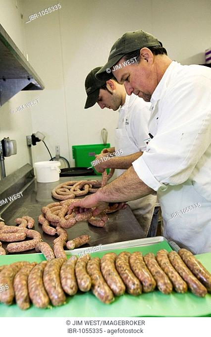 Dennis Wolf, foreground, and Anthony DeMaria making sausages at Nino Salvaggio International Marketplace, Clinton Township, Michigan, USA