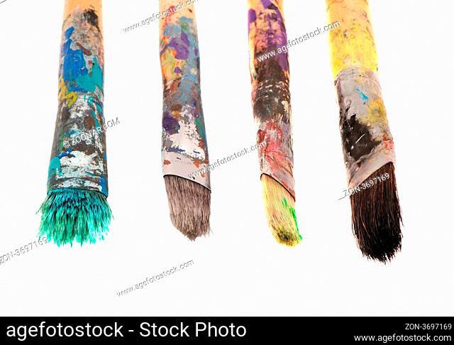 Dirty wooden paint brushes isolated on white background