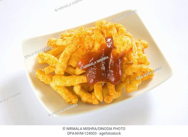 Snack-Junk Food Crisp Crunchy & Spicy Deep Fry in Oil Made from Rice Flour Served with Tomato Ketchup , India