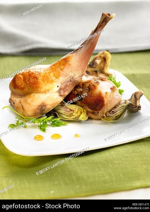 grilled rabbit with lemon and artichokes, flavored with honey