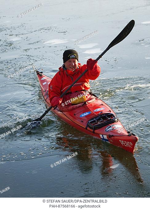 Peer Schmidt-Walther makes his way through the canal on his open-water kayak during sunny weather in Stralsund, Germany, 27 January 2017
