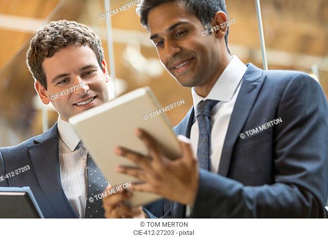 Businessmen working with digital tablet in office