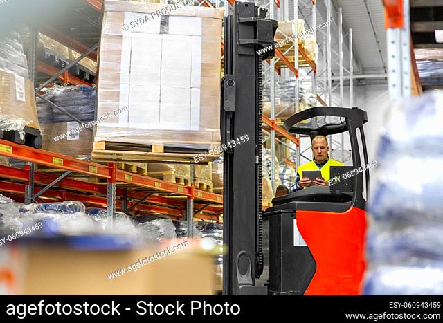 loader with tablet pc on forklift at warehouse
