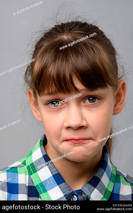 Portrait of a ten-year-old girl with a pitying look, European appearance, close-up