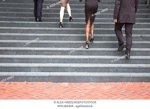 Business people walking up steps