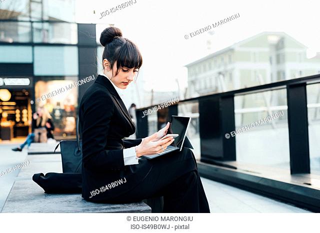 Businesswoman using digital tablet, Milan, Italy