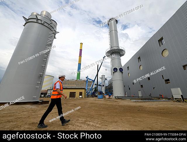 PRODUCTION - 15 July 2021, Saxony, Chemnitz: Tino Schlemmer, project manager of the new gas engine power plant of the energy supplier Eins at the combined heat...