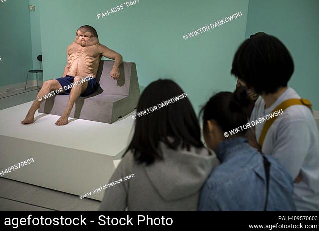 People look at Graham a sculpture of deformed man by Patricia Piccinini during the SUPERNATURAL: Sculptural Visions of the Body exhibition in Taipei