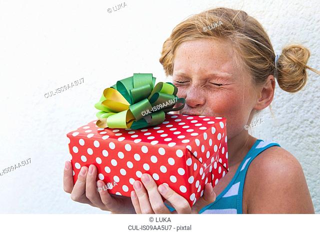 Girl kissing gift in hand