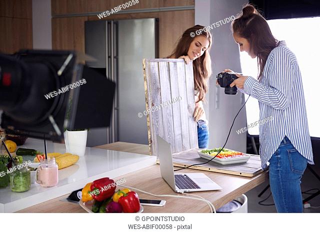 Bloggers photographing food in kitchen