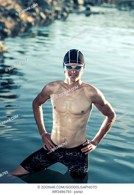 Swimmer model in a sea at sunset