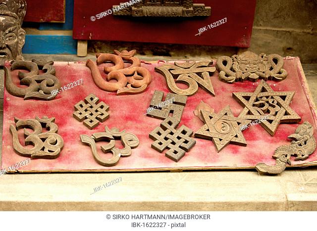 Hindu and Buddhist symbols, including the swastika, the Star of David and the Aum symbol, Om symbol, in a shop window, Patan, Nepal, Asia