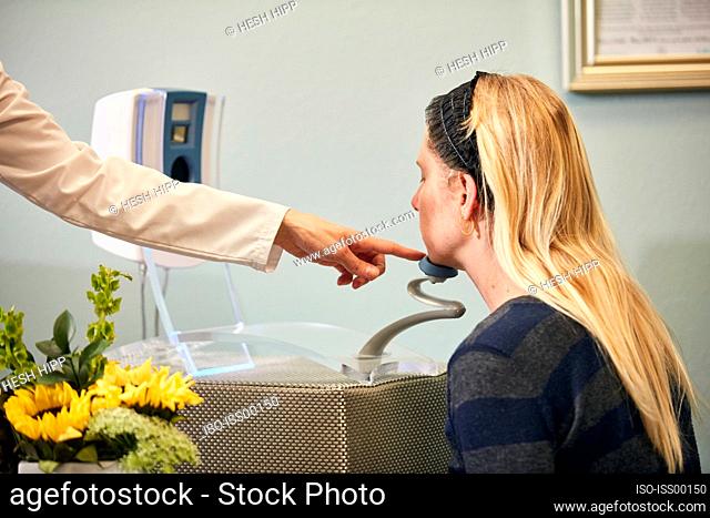 Patient at beauty spa getting skin diagnosis