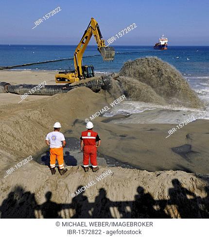 Onlookers watching while a dredger is pumping sand through a hose onto a beach for beach nourishment or beach replenishment, Platja de Barceloneta, Barcelona