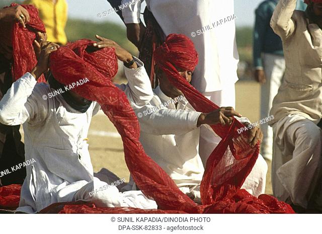 Turban tying contest , Desert Festival , Jaisalmer , Rajasthan , India