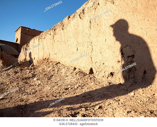 Visitor shadow on ruined wall in Ait Ben Haddou, Morocco