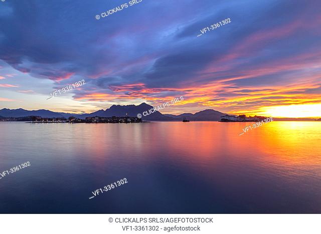 View of the Borromean Islands, Isola dei Pescatori and Isola Bella, from the shore of Baveno in a winter sunrise, Verbano Cusio Ossola, Lago Maggiore, Piedmont