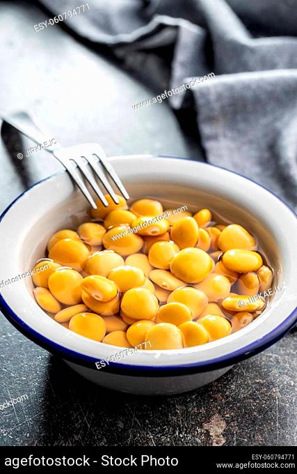 Pickled yellow Lupin Beans in bowl on kitchen table