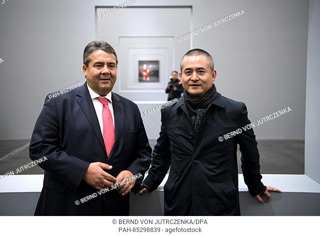 The German Minister for Economic Affairs Sigmar Gabriel (SPD) with Chinese artist Zeng Fanzhi (R) at an exhibition of the latter's work in the Ullens Center for...