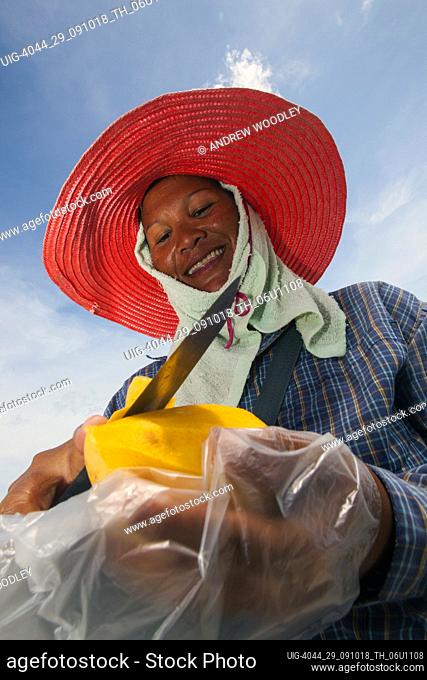 Woman peels mango snack Chaweng Beach Ko Samui Thailand