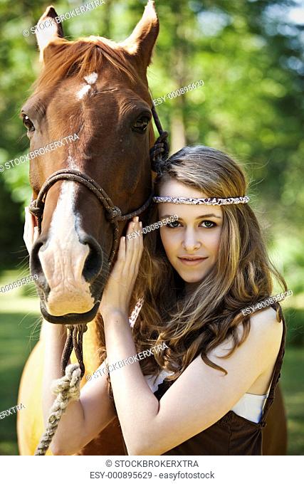 A portrait of a caucasian girl with her horse