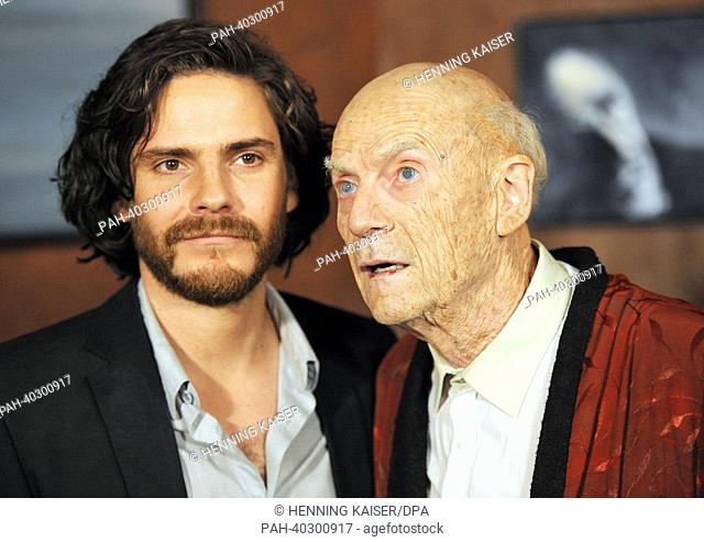 German actor Daniel Bruehl (L, as Sebastian Zoellner) and Danish actor Jesper Christensen (in the mask of Manuel Kaminski) pose during a photocall during the...