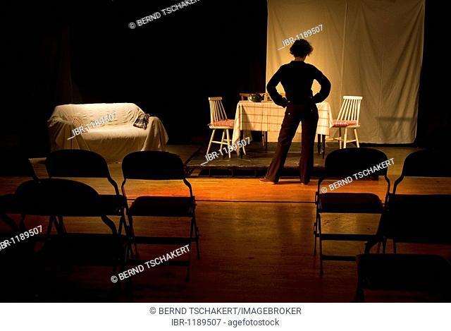 Woman standing on a stage, theatre, England, United Kingdom, Europe