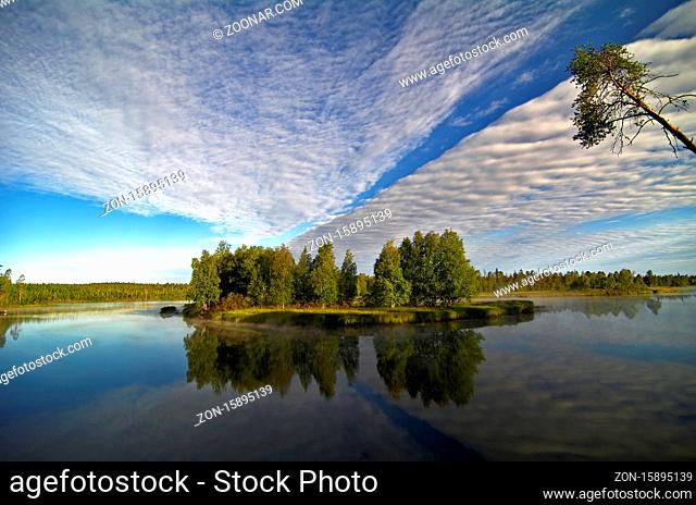 Russia, North Karelia, the river Chirka-Kem. Early morning. Reflection of clouds in the water