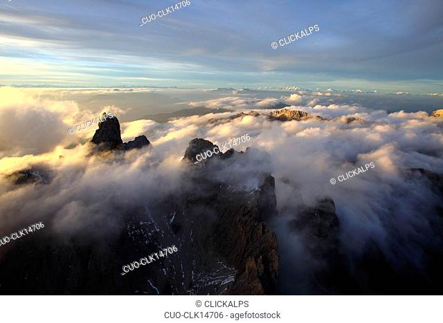 Aerial view of the mountain range of Odle surrounded by clouds, Dolomites, Val Funes, Trentino-Alto Adige, South Tyrol, Italy, Europe