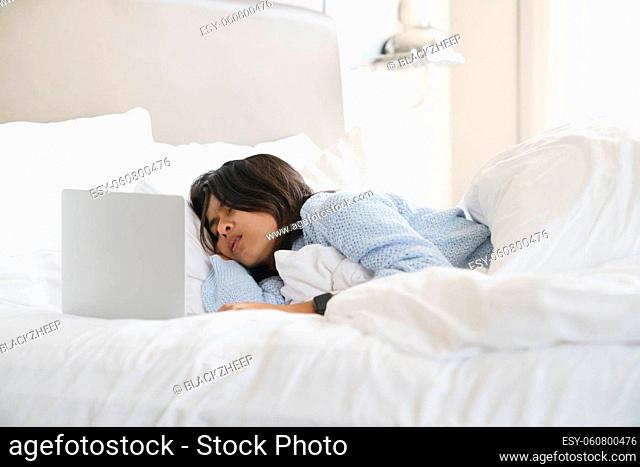 woman sleeping after use computer overwork on bed