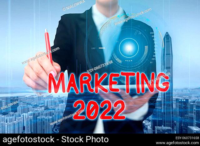 Hand writing sign Marketing 2022, Conceptual photo Commercial trends for 2022 New Year promotional event Doctor In The Laboratory Holding A Tablet Showing...
