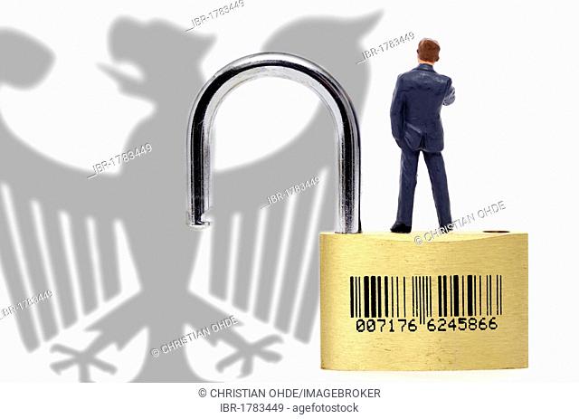 Miniature figure standing on an open padlock with a bar code, data security during a population census