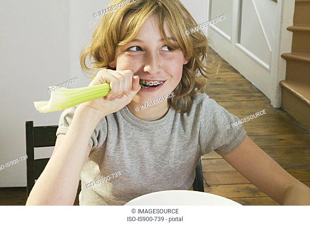 Girl biting a celery stick