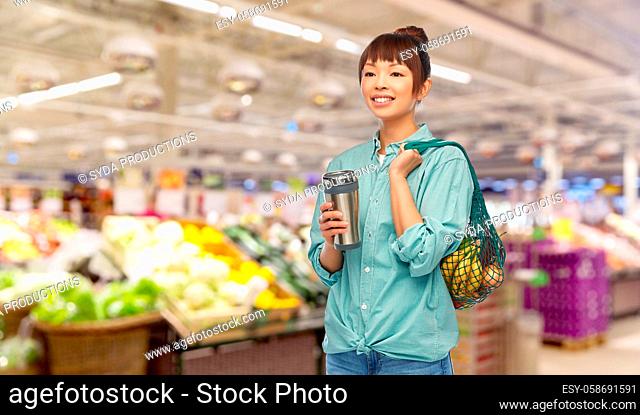 woman with thermo cup or tumbler for hot drinks