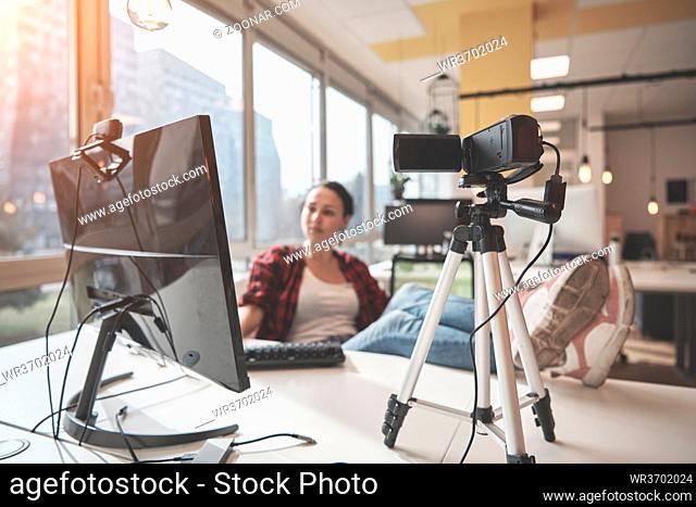 online education elearning concept with young student or businesswoman at office filming with camera from tripod