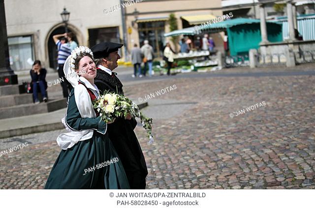 This year's Luther couple Maria Jana Palaschevsky as Katharina von Bora and Fred Goede as Martin Luther walk across the market square in Lutherstadt Wittenberg