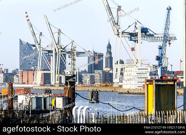 25 December 2020, Hamburg: The Elbphilharmonie behind container cranes of the Hansa harbour, the Kehrwiederspitze and the tower of the main church St