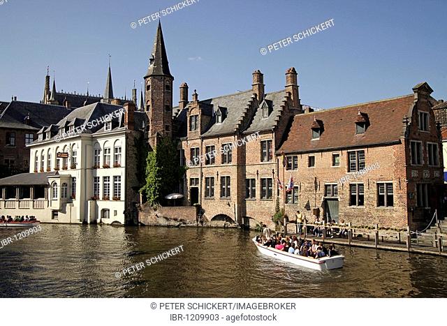 Excursion boat on a canal in the historic centre of Bruges, Belgium, Europe