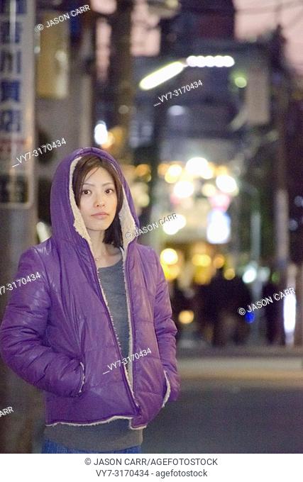 Japanese Girl poses on the street in Aoyama, Japan. Aoyama is a famous area about universities in Tokyo