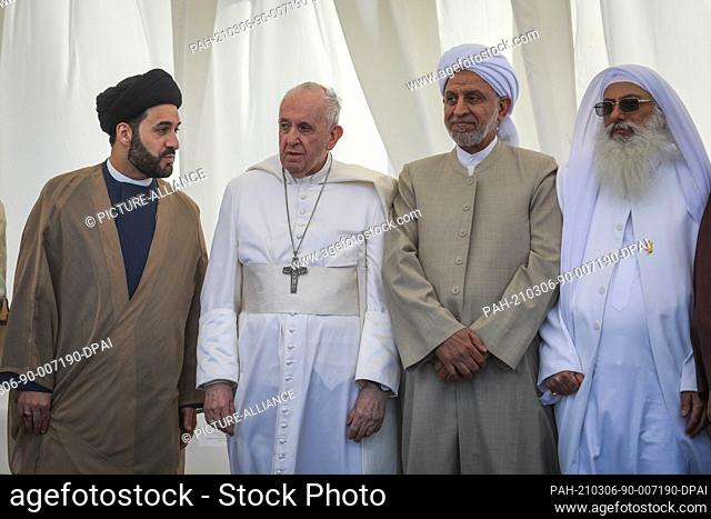 06 March 2021, Iraq, Nasiriyah: Pope Francis (2nd L) and religious clerics from different sects in Iraq attend an interreligious meeting in the Sumerian...