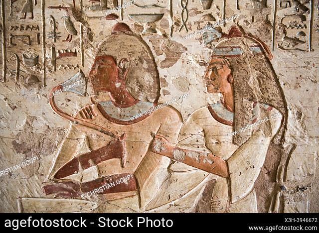 Painted engravings of the tomb of Setau, showing him with his wife smelling a lotus flower. El Kab necropolis on the east bank of the Nile, Egypt