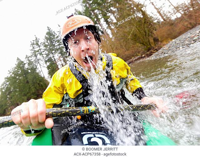 Dave Prothero comes out of an eskimo roll while paddling on the Puntledge River near Courtenay. Courtenay, The Comox Valley, Vancouver Island, British Columbia
