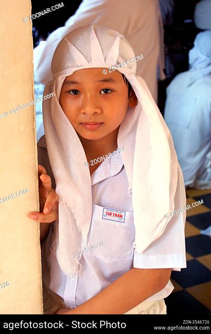 Young monk in the temple cao dai in south Vietnam