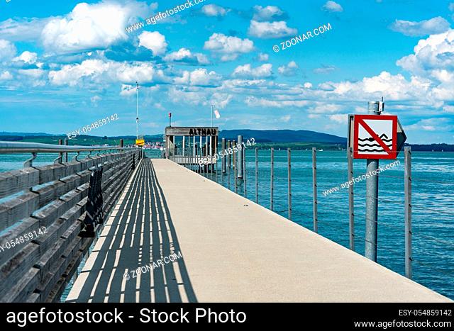 Altnau, TG / Switzerland - 14. July 2019: close up view of the long pier at Altnau on Lake Constance with a no swimming sign because of passenger ship traffic...