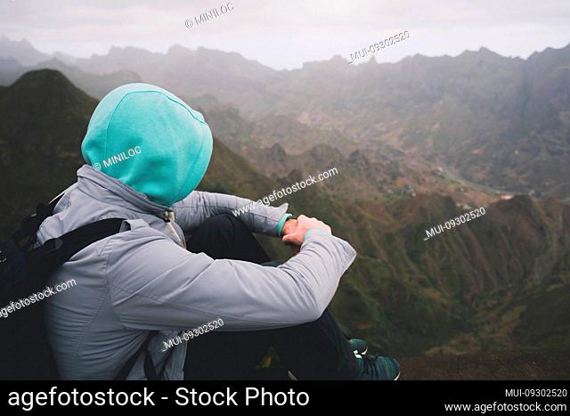 Traveler enjoying magnificent remote moment above huge mountain ranges on Santo Antao island, Cape Verde