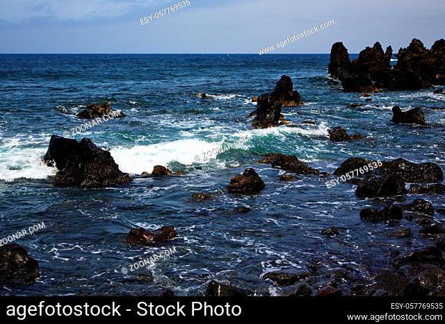 rock spain sky light beach water in lanzarote isle foam landscape stone cloud