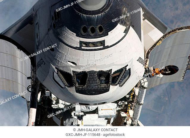 This view of the nose, crew cabin and forward payload bay of the space shuttle Endeavour was provided by an Expedition 27 crew member during a survey of the...