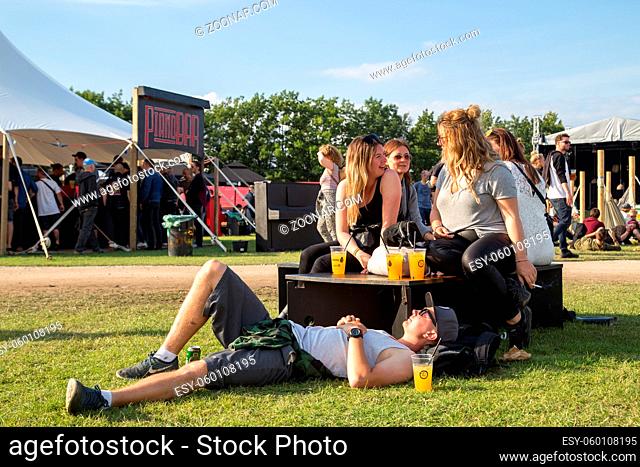Roskilde, Denmark - June 29, 2016: People talking and enjoying sunshine at a bar at Roskilde Festival