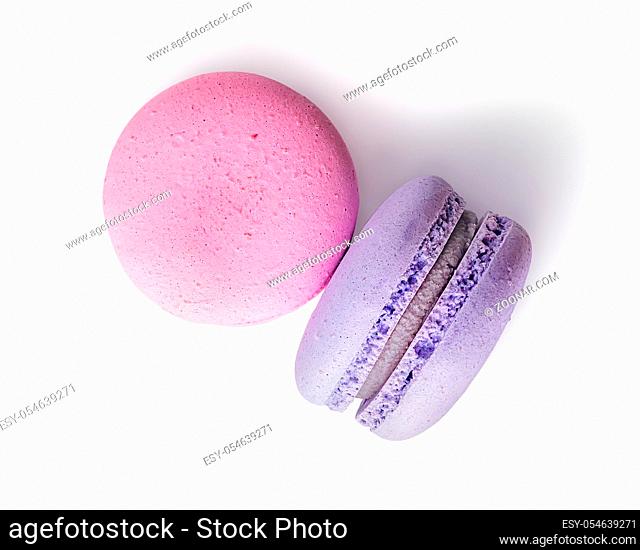 Two macaroon pink purple top view on white background