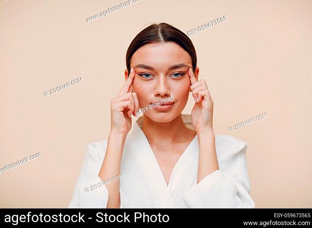 Young beautiful woman doing face building facial gymnastics self massage